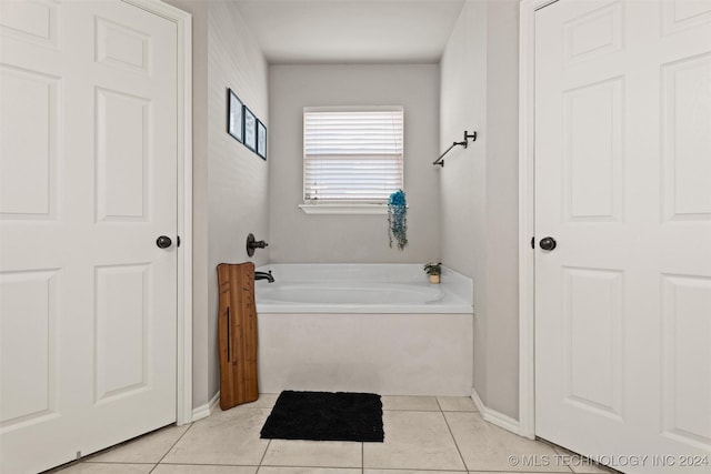 bathroom featuring tile patterned floors and a washtub