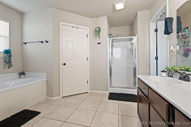 bathroom with tile patterned flooring, vanity, and shower with separate bathtub