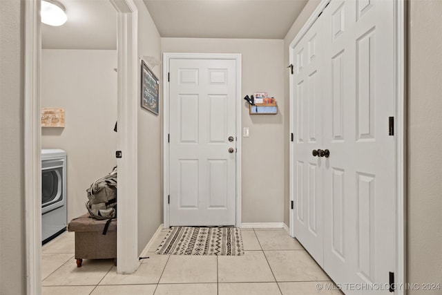 doorway featuring light tile patterned floors and washer / dryer