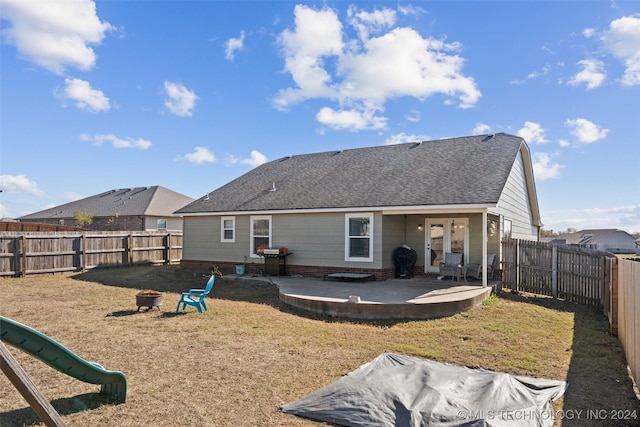 back of property featuring a patio and a playground