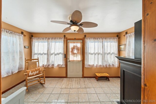 interior space with a wealth of natural light and ceiling fan