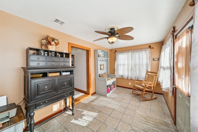 misc room with ceiling fan and light tile patterned floors