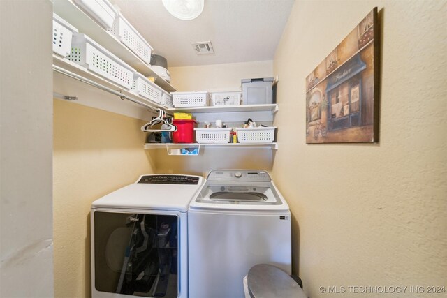 laundry area featuring washing machine and dryer