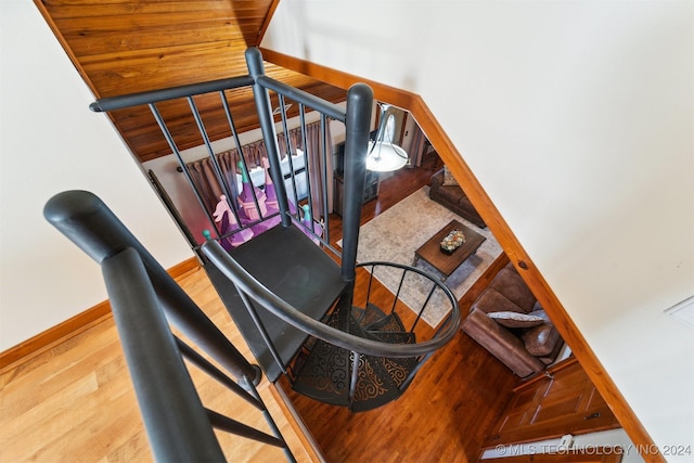 stairs featuring hardwood / wood-style floors