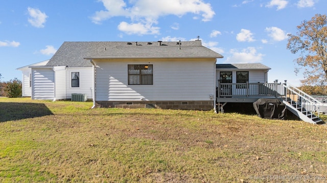 back of property with central AC unit, a yard, and a deck