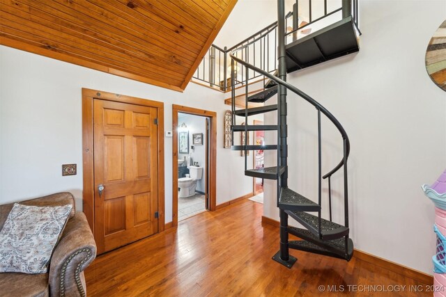 entrance foyer featuring wood ceiling, wood-type flooring, and vaulted ceiling