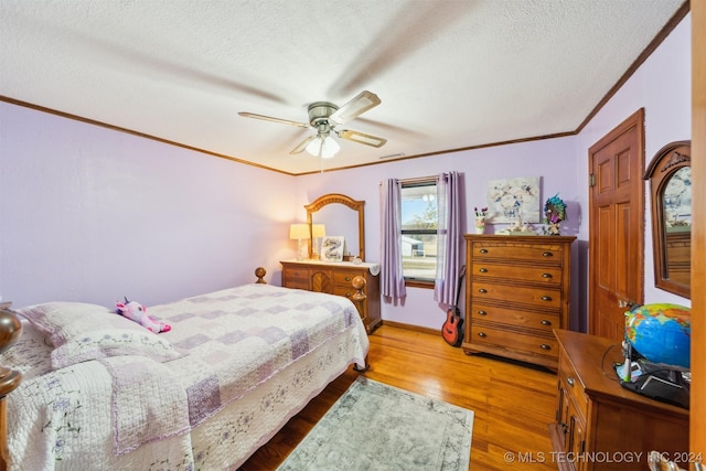 bedroom with crown molding, ceiling fan, hardwood / wood-style floors, and a textured ceiling