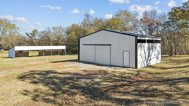 view of outbuilding with a yard and a carport