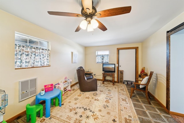 game room featuring ceiling fan and heating unit