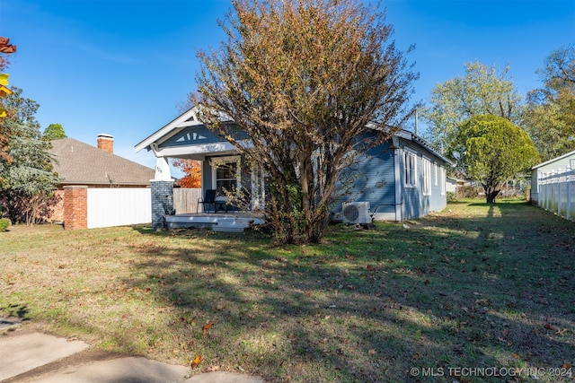 view of front of home with a porch and a front yard