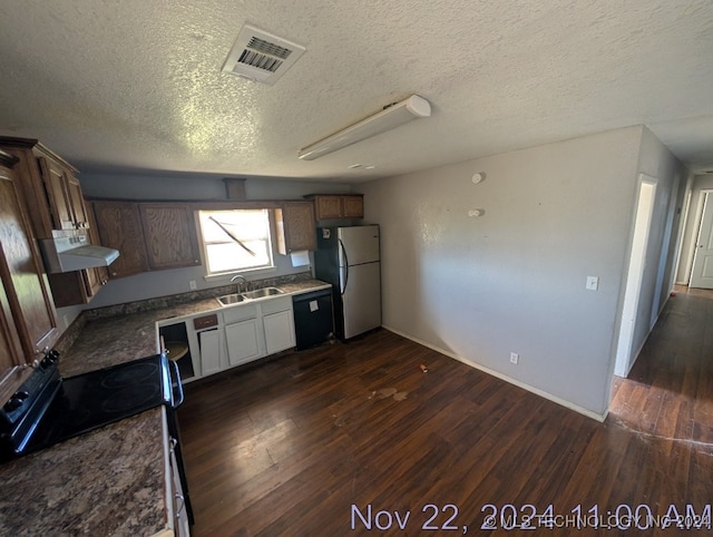 kitchen with a textured ceiling, dark hardwood / wood-style floors, extractor fan, and black appliances