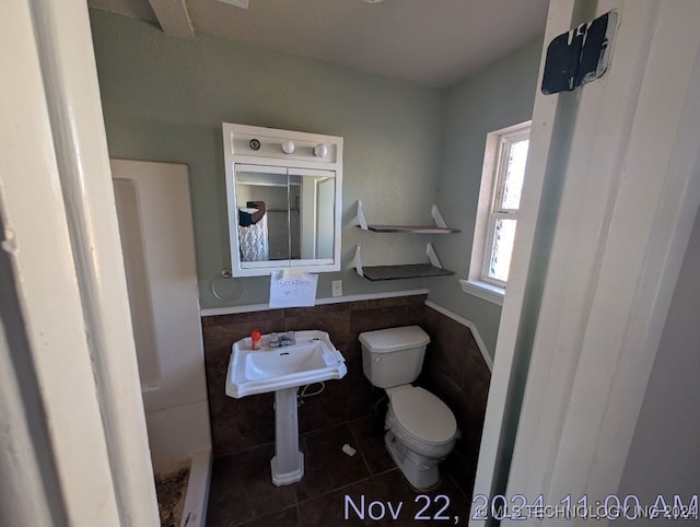 bathroom with tile patterned floors and toilet