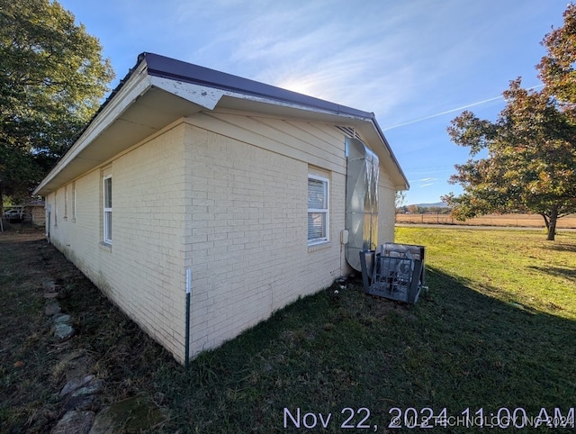 view of side of home with a lawn