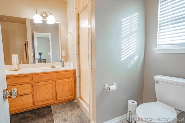 bathroom with vanity, an enclosed shower, and toilet