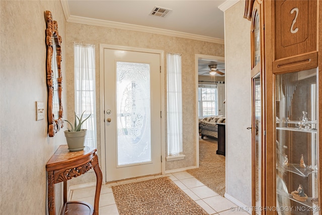 tiled foyer entrance with crown molding