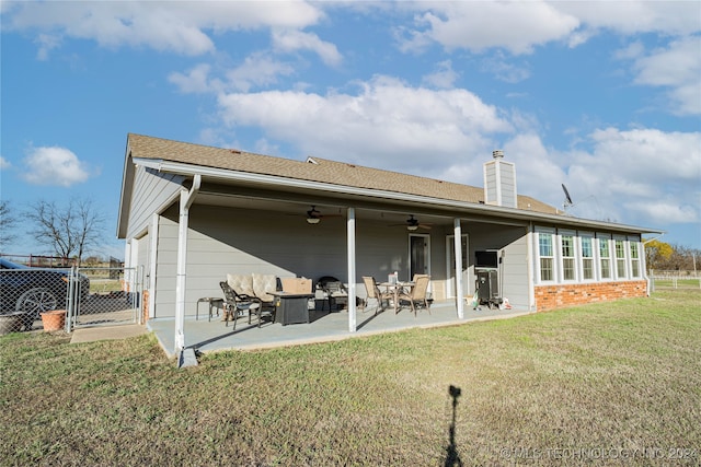 rear view of house featuring a patio, ceiling fan, and a lawn