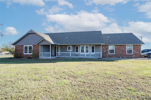 single story home featuring covered porch and a front lawn