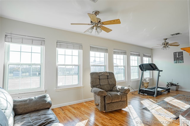 workout area featuring light hardwood / wood-style flooring and ceiling fan