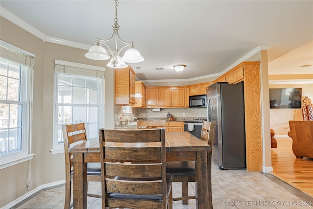 dining room with crown molding, light tile patterned floors, and an inviting chandelier