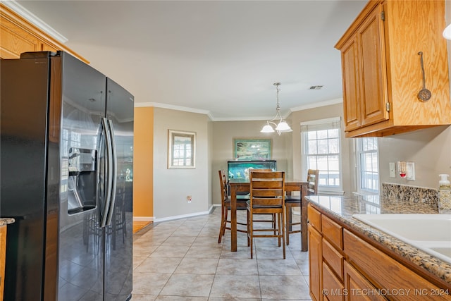 kitchen featuring sink, stainless steel fridge, hanging light fixtures, ornamental molding, and light tile patterned floors