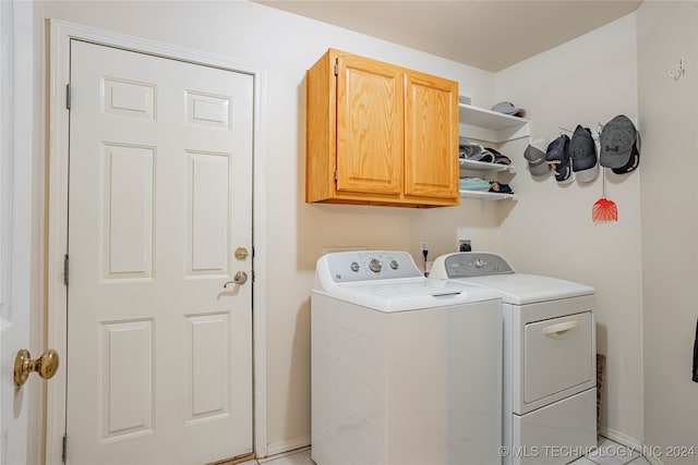 laundry room with cabinets and washer and dryer