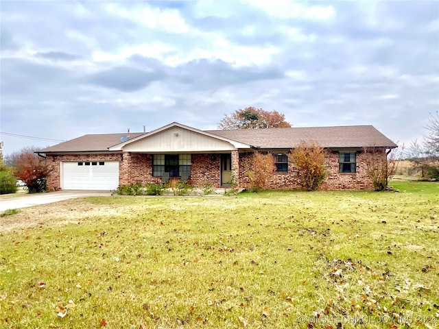 ranch-style home featuring a garage and a front lawn