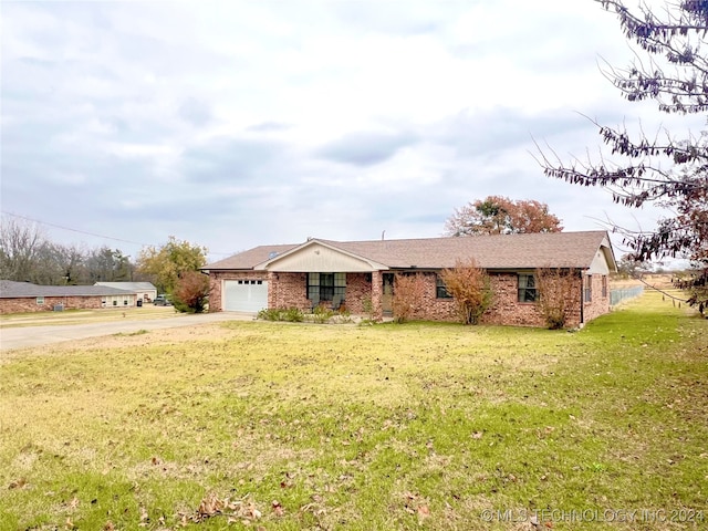 single story home with a garage and a front lawn