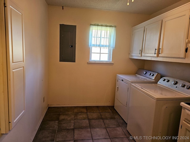 washroom featuring washer and dryer, cabinets, a textured ceiling, and electric panel