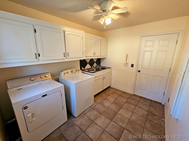 washroom with ceiling fan, sink, cabinets, a textured ceiling, and washer and clothes dryer