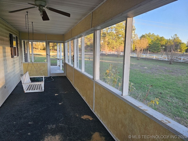 unfurnished sunroom with a wealth of natural light and ceiling fan