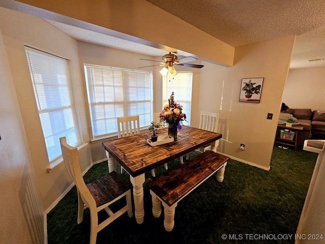 carpeted dining space with ceiling fan and a textured ceiling