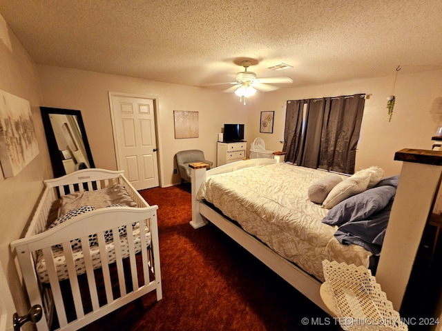 carpeted bedroom with a textured ceiling and ceiling fan