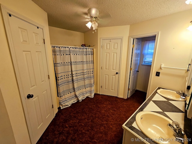 bathroom with vanity, a shower with curtain, a textured ceiling, and ceiling fan