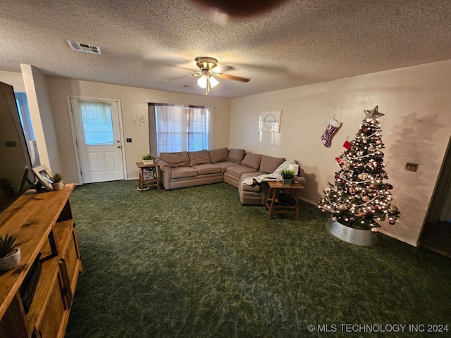 carpeted living room with ceiling fan and a textured ceiling