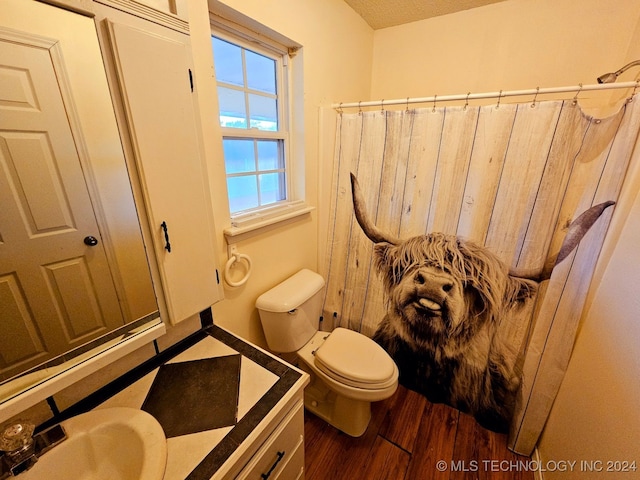 bathroom with walk in shower, sink, toilet, and hardwood / wood-style flooring