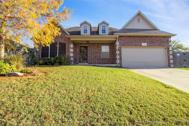 view of front of property with a garage and a front lawn