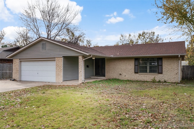 ranch-style house featuring a garage and a front lawn