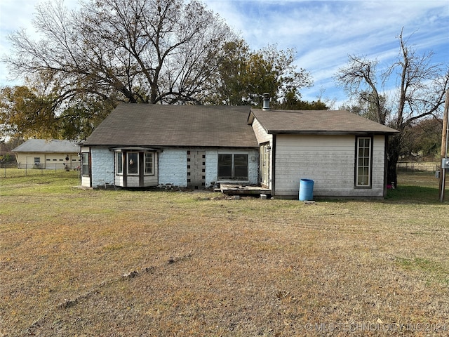 back of house with a yard