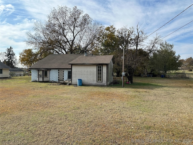 rear view of property with a yard