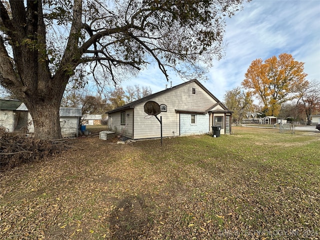 view of side of home with a lawn