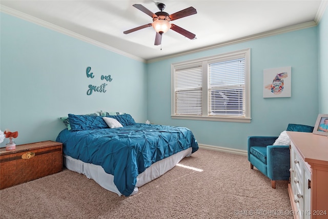 carpeted bedroom with ceiling fan and ornamental molding