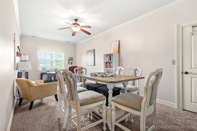 dining room featuring ceiling fan, carpet floors, and crown molding