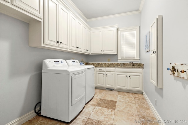 laundry room with cabinets, separate washer and dryer, ornamental molding, and sink