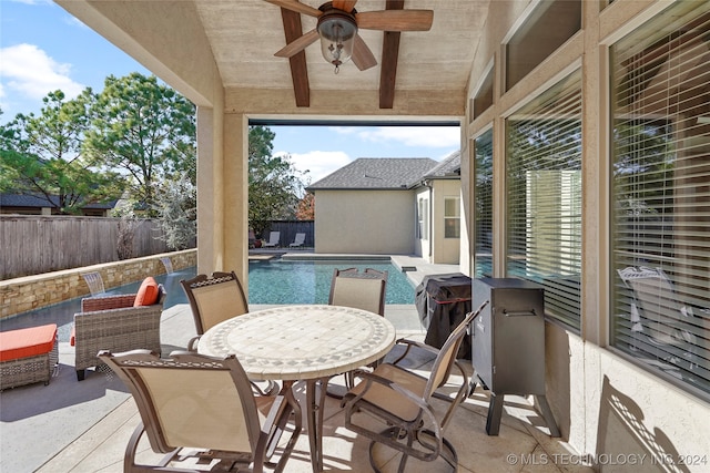 view of patio with ceiling fan and a fenced in pool