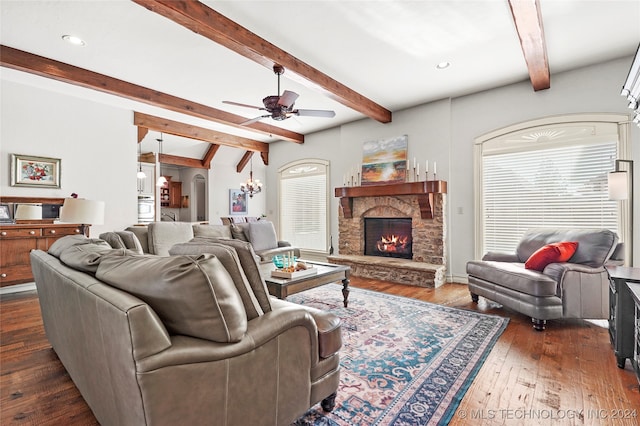 living room with dark hardwood / wood-style floors, beam ceiling, and a wealth of natural light