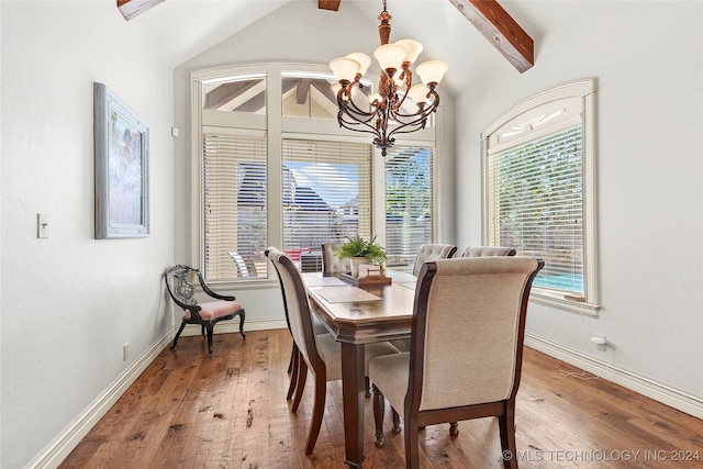 dining space with hardwood / wood-style floors, vaulted ceiling with beams, and a notable chandelier