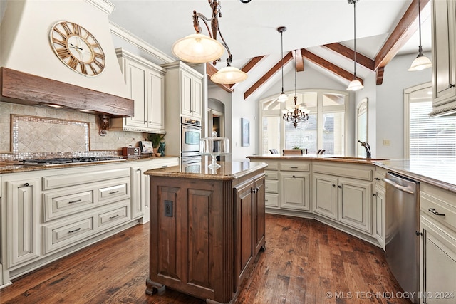 kitchen with appliances with stainless steel finishes, dark hardwood / wood-style flooring, tasteful backsplash, pendant lighting, and cream cabinets