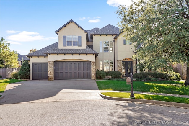 view of front of property featuring a front yard and a garage