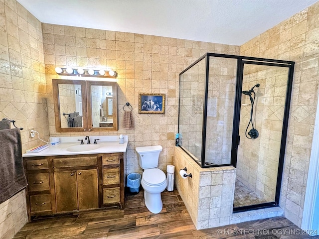 bathroom with walk in shower, hardwood / wood-style floors, toilet, and tile walls