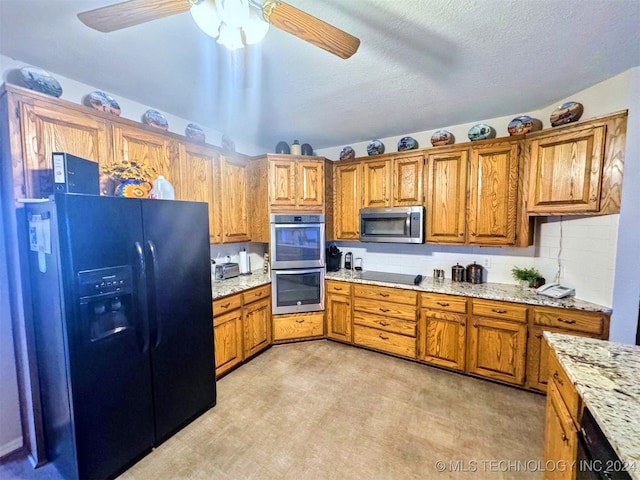 kitchen with light stone countertops, backsplash, a textured ceiling, ceiling fan, and black appliances